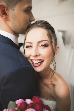 Portrait of happy newly wedding couple with bouquet.の写真素材