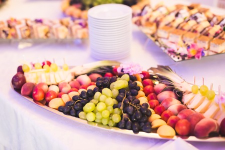 Different fresh fruits on wedding buffet table.