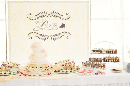 Delicious and tasty dessert table with cupcakes and shots at reception closeup.の写真素材