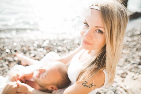 happy just married young couple celebrating and have fun at beautiful beach sunset.の写真素材