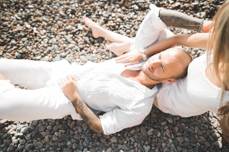 happy just married young couple celebrating and have fun at beautiful beach sunset.の写真素材
