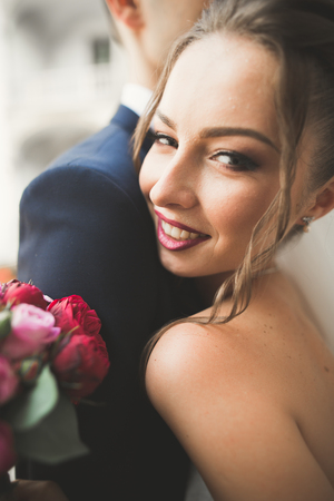Portrait of happy newly wedding couple with bouquet.の写真素材