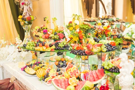 Different fresh fruits on wedding buffet table.の写真素材