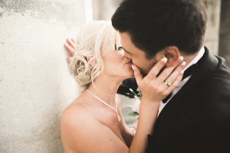 Kissing wedding couple in spring nature close-up portrait.の写真素材