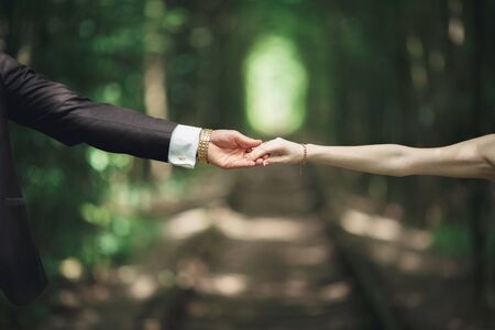Wedding couple bride and groom holding hands.の写真素材