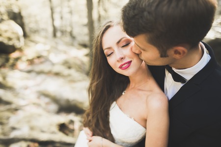Beautiful, perfect happy bride and groom posing on their wedding day. Close up portraitの写真素材