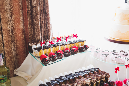 Delicious sweets on wedding candy buffet with desserts, cupcakesの写真素材