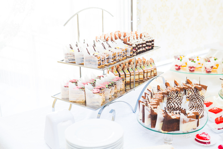 Delicious sweets on wedding candy buffet with desserts, cupcakesの写真素材