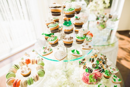 Delicious sweets on wedding candy buffet with desserts, cupcakesの写真素材