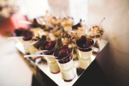 Delicious sweets on wedding candy buffet with desserts, cupcakes.の写真素材
