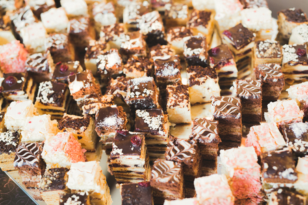 Different kinds of baked sweets on a buffet.の写真素材