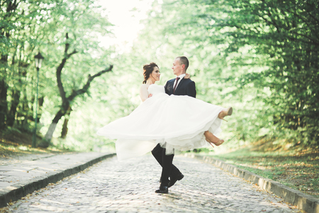 Happy wedding couple bride and groom posing in a botanical parkの写真素材