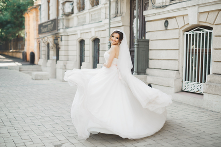 Beautiful bride posing in wedding dress outdoorsの写真素材