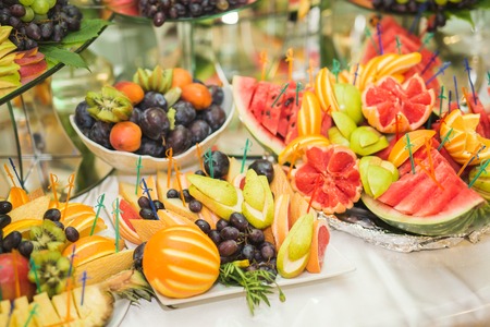 Various sweet sliced fruit on a buffet table.