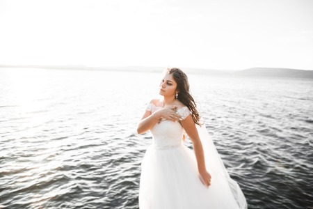Beautiful young bride posing on the background seaの写真素材