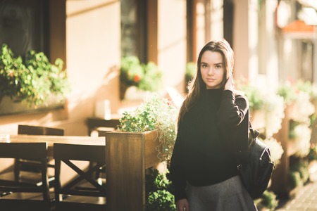 Beautiful young woman posing on the street in old cityの写真素材