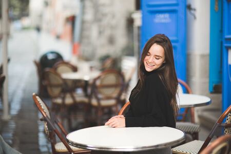 Fashion woman portrait of young pretty trendy girl posing at the city in Europeの写真素材