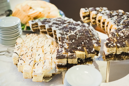 Delicious sweets on wedding candy buffet with desserts, cupcakes.の写真素材