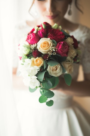 Luxury bride in white dress posing while preparing for the wedding ceremonyの写真素材
