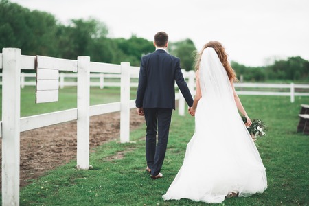 Portrait of happy newly wedding couple with bouquetの写真素材