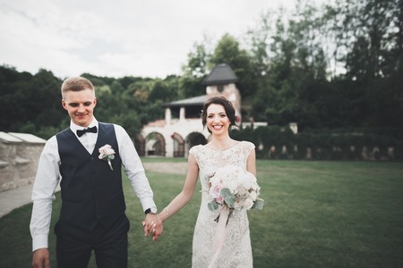 Perfect couple bride, groom posing and kissing in their wedding dayの写真素材