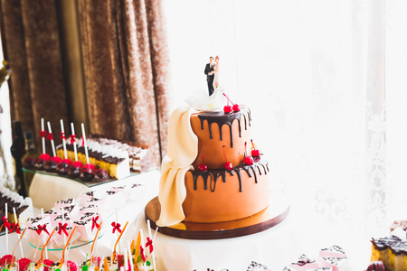 Delicious sweets on wedding candy buffet with desserts, cupcakesの写真素材
