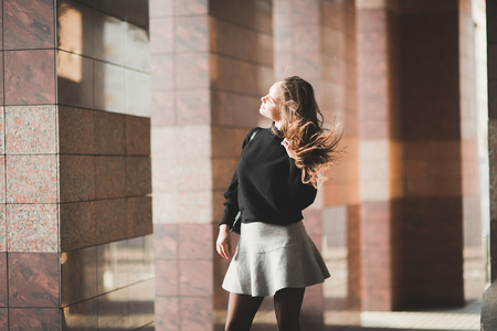 Beautiful young woman posing on the street in old cityの写真素材