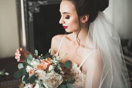Portrait of beautiful bride with fashion veil at wedding morningの写真素材
