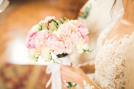 Bride holding big and beautiful wedding bouquet with flowersの写真素材