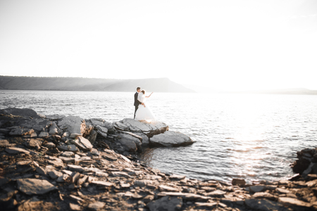 Happy and romantic scene of just married young wedding couple posing on beautiful beachの写真素材