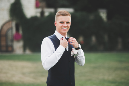 Headshot portrait of young man smiling isolated on outside outdoors backgroundの写真素材