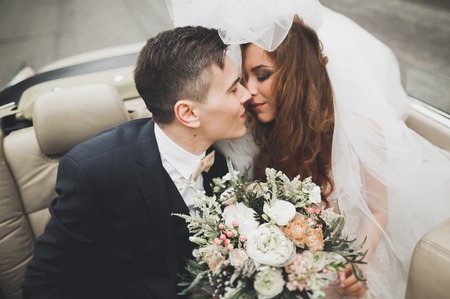 Just married couple in the luxury retro car on their wedding dayの写真素材