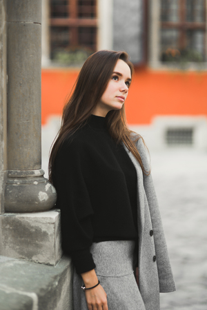 Fashion woman portrait of young pretty trendy girl posing at the city in Europeの写真素材