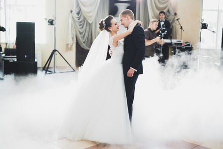 First wedding dance of newlywed couple in restaurantの写真素材