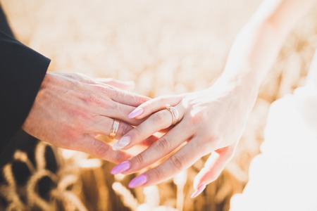 Wedding couple bride and groom holding hands.の写真素材