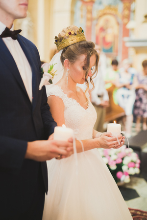 Wedding couple bide and groom get married in a churchの写真素材