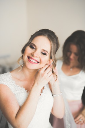 Portrait of beautiful bride with fashion veil at wedding morningの写真素材