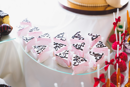 Delicious and tasty dessert table with cupcakes shots at reception closeupの写真素材