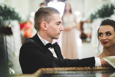 Wedding couple bide and groom get married in a churchの写真素材