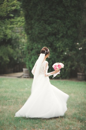 Portrait of stunning bride with long hair posing with great bouquet.の写真素材