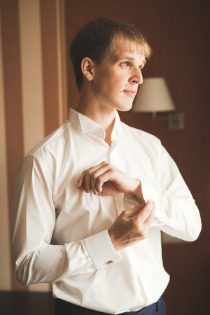 Beautiful man, groom posing and preparing for weddingの写真素材