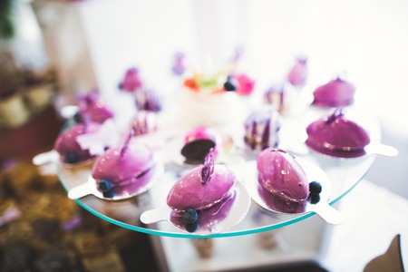 Delicious sweets on wedding candy buffet with desserts, cupcakesの写真素材