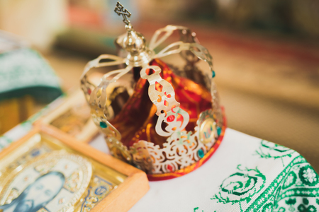 Golden crowns lying on the table in churchの写真素材