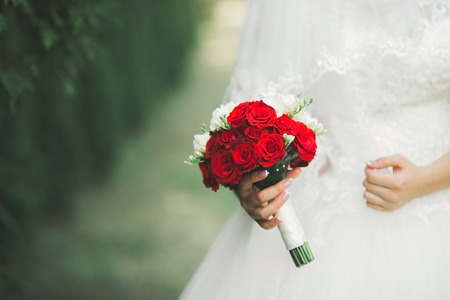 Bride holding big and beautiful wedding bouquet with flowersの写真素材