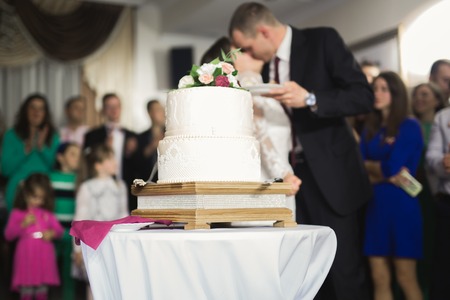 Bride and groom at wedding cutting the wedding cakeの写真素材
