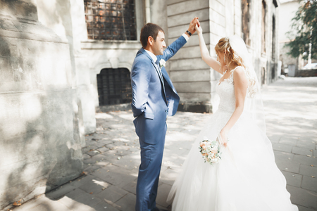 Beautiful caucasian wedding couple just married and dancing their first danceの写真素材