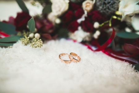 Two golden wedding rings isolated background conceptの写真素材