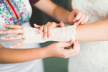 Gorgeous bride in robe posing and preparing for the wedding ceremony face in a roomの写真素材