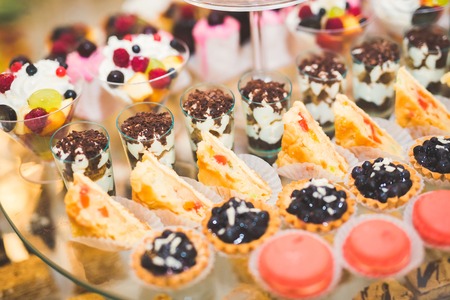 Delicious sweets on wedding candy buffet with desserts, cupcakesの写真素材