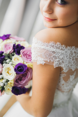 Beautiful bride posing in wedding dress outdoorsの写真素材